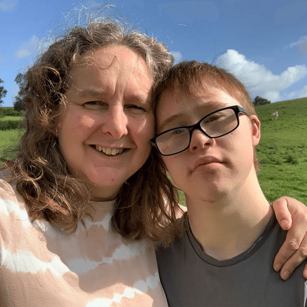 Mother with teenage son outside in nature posing for a picture