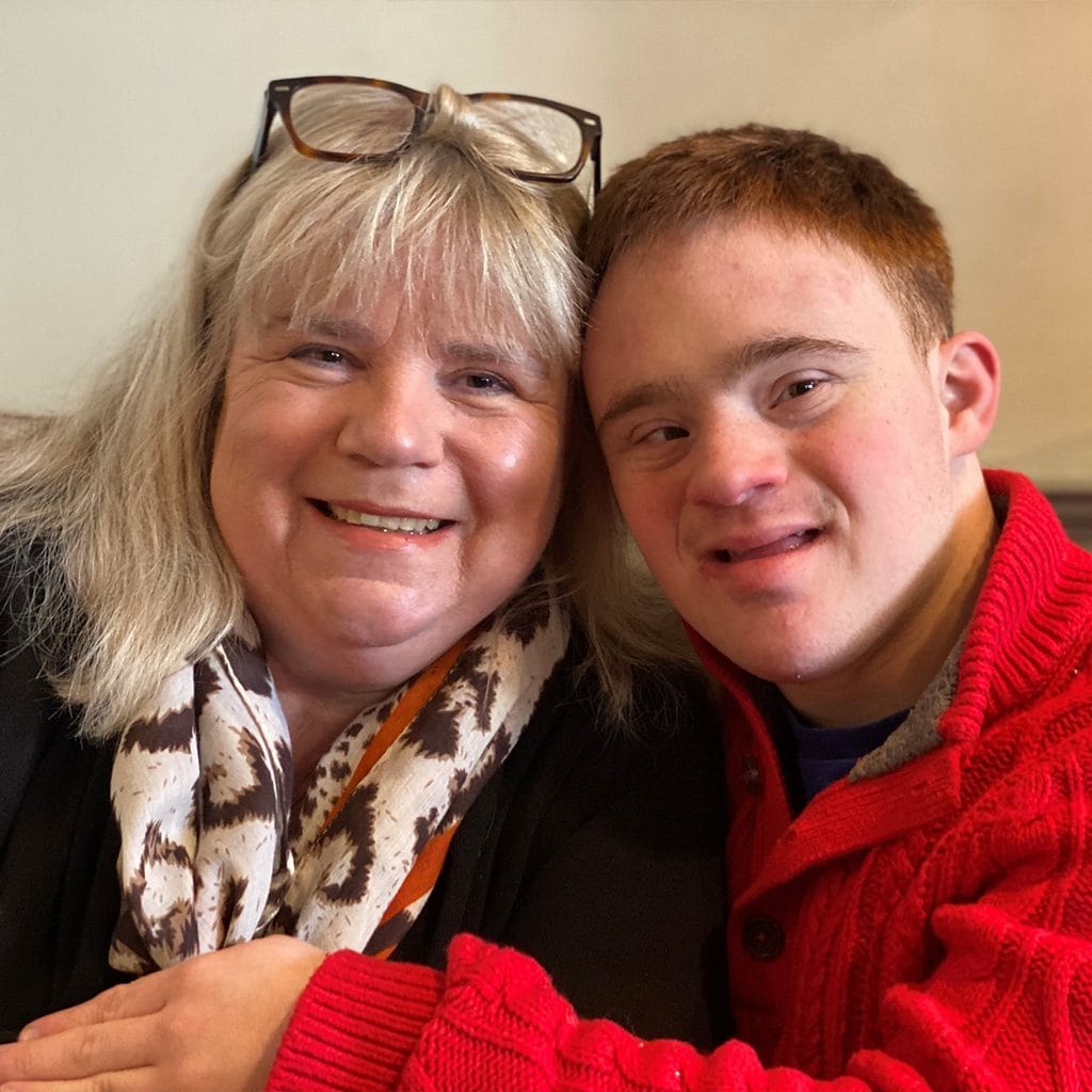 Nicola Enoch, CEO of Down Syndrome UK posing in a picture with her son Tom