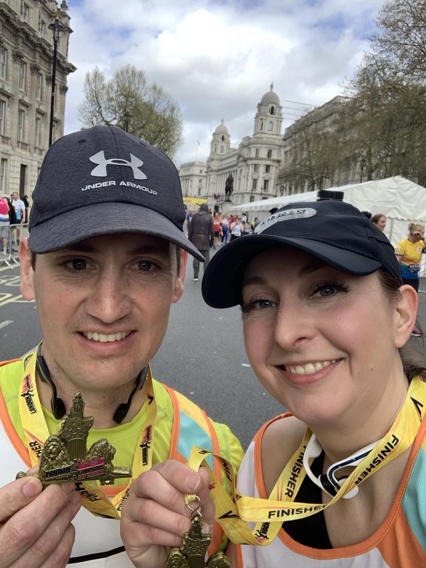 Man and woman complete London Landmarks holding medals