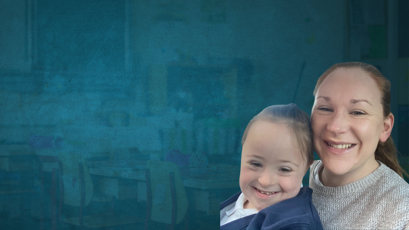 Victoria McDonnell and her daughter Ivy who has down syndrome, Vicky is hugging her daughter from behind as they both smile for a photo