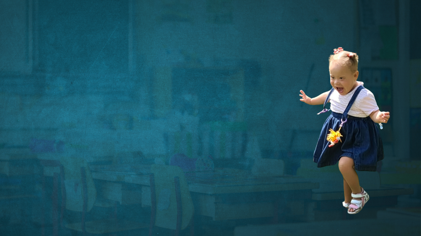 Child skipping along very happily with dungarees on