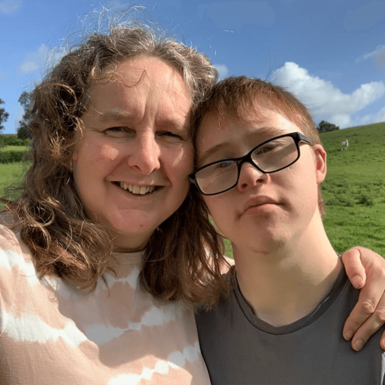 Mother with teenage son outside in nature posing for a picture