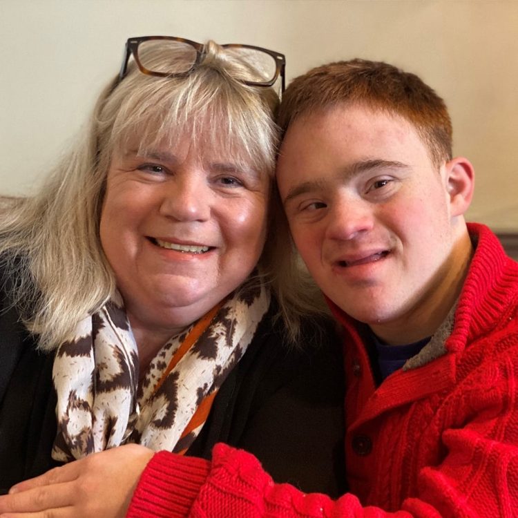Nicola Enoch, CEO of Down Syndrome UK posing in a picture with her son Tom